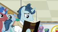 Student 1 reading a textbook S8E16
