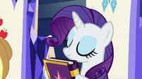 Rarity sniffs her copy of the friendship journal S7E14