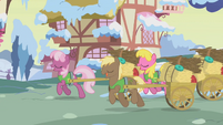 Cheerilee, the second appearance, again with a green vest. She, Coco Crusoe, and Cherry Berry are delivering nest-making materials to ponies' houses.