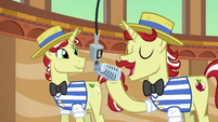 Flam speaking into the microphone S6E20