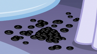 Pile of black buttons on the boutique floor S7E9