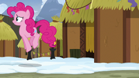 Pinkie Pie hopping away from a mud hut S7E11