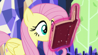 Fluttershy looking at Twilight's levitating book S5E23