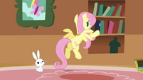 Fluttershy putting the books back into the bookshelf S3E10