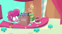 Pinkie looking at the box of film reels PLS1E6a