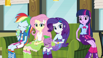 Spike sleeping on Rarity's legs.