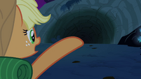 Applejack points at the cave S3E06