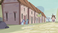 Two ponies standing and smiling in front of a house S5E02