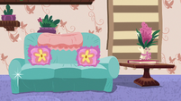 Fancy couch and flowers in a vase S7E12