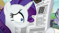 Rarity tearing up behind the newspaper S7E14