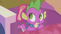 Star Swirl's scroll floats out of Spike's backpack S5E25