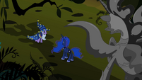 Twilight Sparkle and Princess Luna under the shadow of the statue of Nightmare Moon.