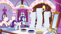 Rarity pointing at rolls of fabric S6E11