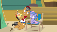 Quibble holding the museum brochure S9E6
