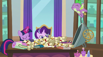 Spike dumps binders and scrolls on Twilight's desk S8E15