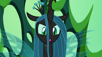Queen Chrysalis sitting upon her throne S6E26