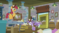 Purple pony kicks Big Mac's box into the cart.