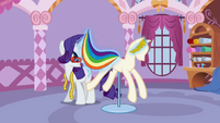 Rarity putting the rainbow-striped fabric on the mannequin S1E14