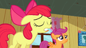 Apple Bloom's tongue is sticking out from under her bottom row of teeth.