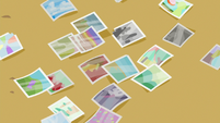 Photos scattered on the table S6E21
