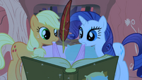 Applejack and Rarity looking at Twilight's book S1E08