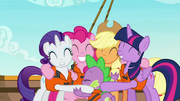 Ponies and Spike share a group hug S6E22