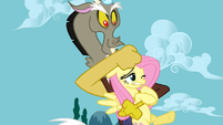 Discord holding Fluttershy.