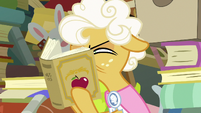 Goldie Delicious squinting at the book S7E13