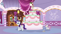 Rarity crosses in front of the giant cake S6E15