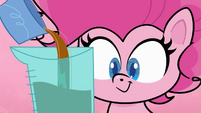 Pinkie pours batter in measuring cup PLS1E1a