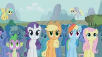 Ponyville fields behind the crowd.