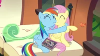 Fluttershy and Rainbow Dash with their respective traded gifts.