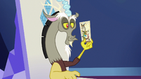 Discord holding his O&O character stand S6E17