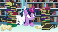 Twilight Sparkle levitates one of the books S6E2