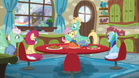 Fluttershy gives her parents a look of disbelief as Zephyr hugs her S6E11