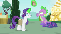 Rarity levitates the book away from Spike S4E23