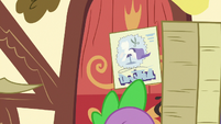 Spike carrying contest flyers behind Rarity S7E9