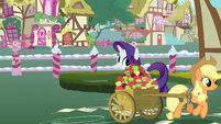 Applejack trots away with her cart of apples S7E9