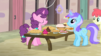 Diamond Mint takes a cupcake from Sugar Belle's table S5E2