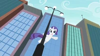 Rarity, dancing from a pole.