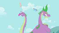 Spike swipes at Fluttershy and Rainbow Dash with tail S2E10