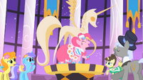 Pinkie Pie stands next to the statue S1E26