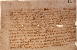 A damaged and aged piece of paper, or parchment, with multiple lines of handwritten English text.