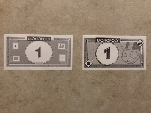 The new 90th anniversary Monopoly money is on the right.