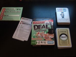 Monopoly Deal, with the rules and cards displayed.