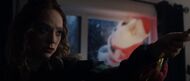 The real Angel throws a Santa Claus decoration through the window, proving her wrong.