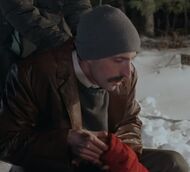 Tony helping Rachel fake her death by pretending to check her pulse.