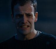 Feigning shock upon seeing Nicole's death.
