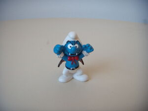 Action figure of a smurf dressed as Dracula