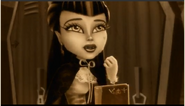 Draculaura closing her locker and looking at Valentine from 400 years ago in her vintage film on her story.